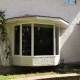 Exterior view of a custom bay window installed by Hi-Tech in Winnipeg's Charleswood neighbourhood. The window has one large pane of glass in the centre and two smaller angled panes on each side.