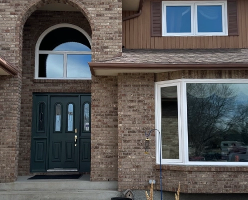 A new bay window installed on a brown brick house in Winnipeg, Manitoba.